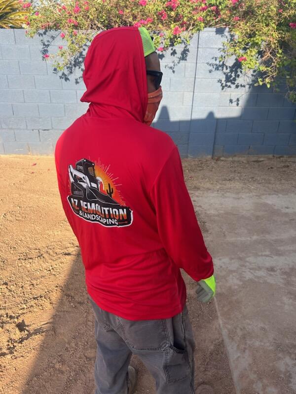 Worker wearing custom red branded hoodie outdoors